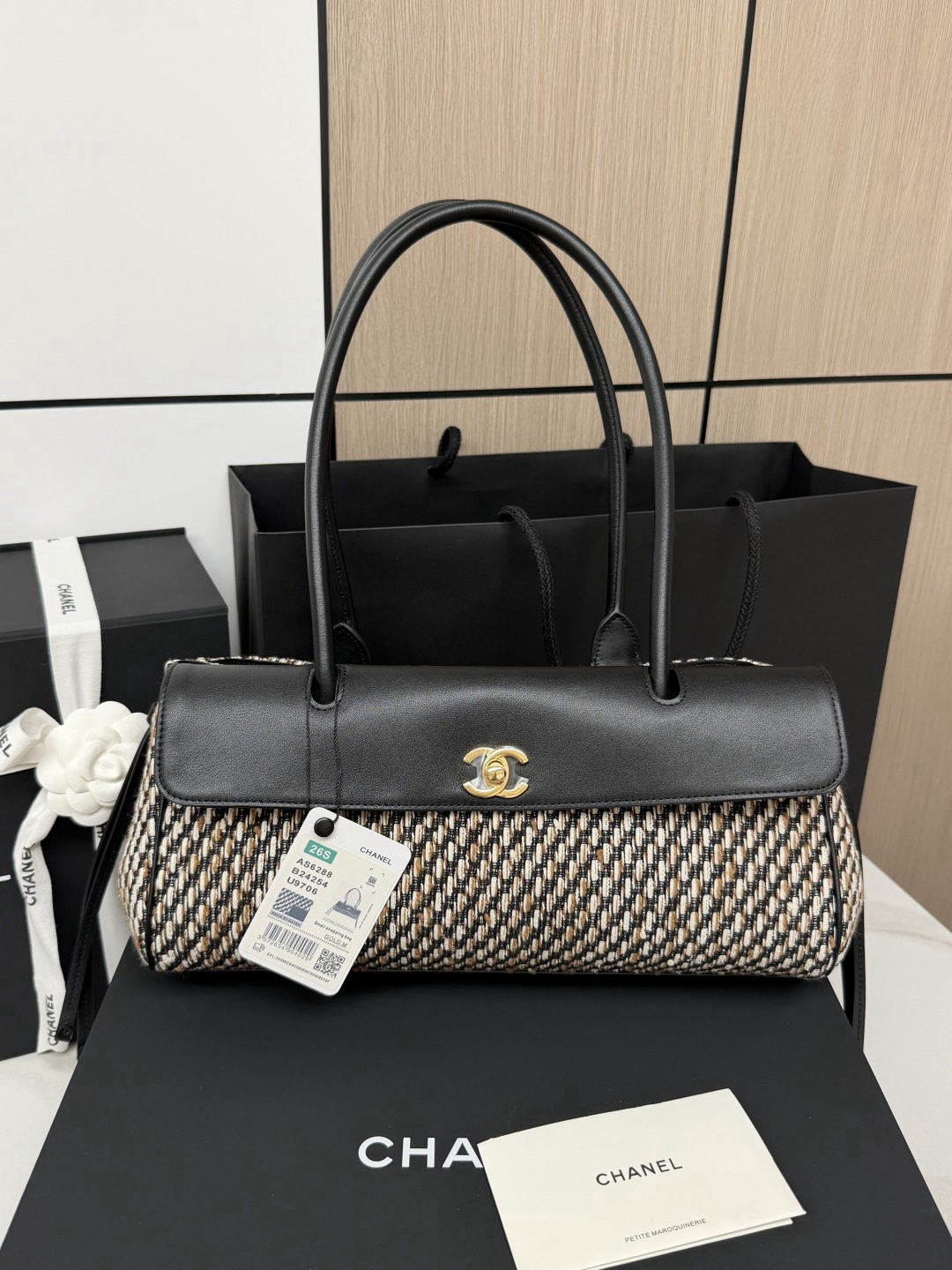 CHANEL baguette bag with lychee pattern and black bowling ball design