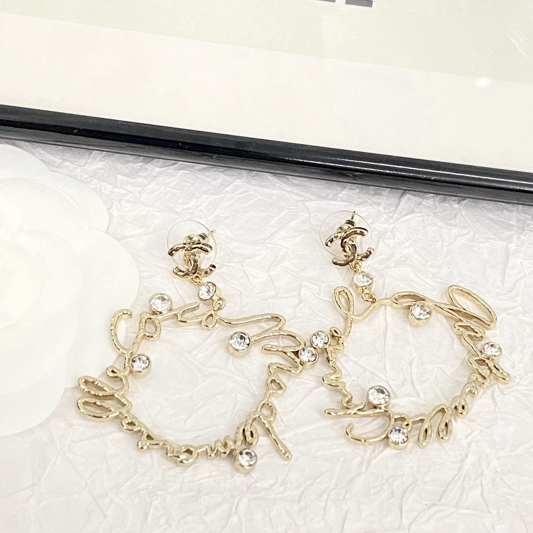 Chanel crystal lettering openwork irregular-shaped earrings
